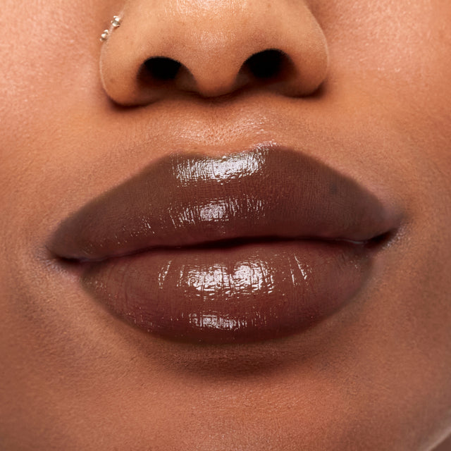 Deep skin tone model wearing Wet Stick in Cinnamon Spritz