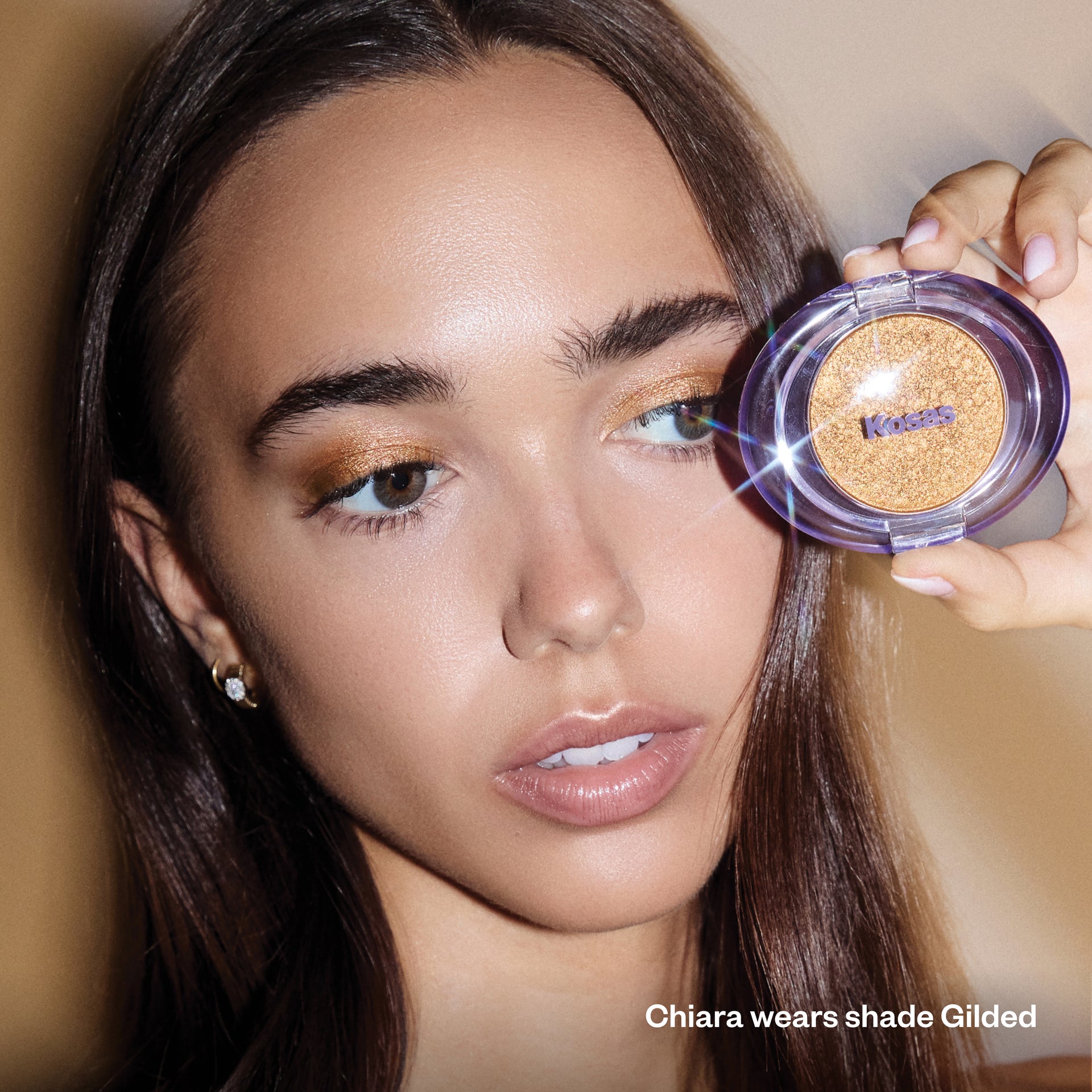 Model holding Shiny Objects