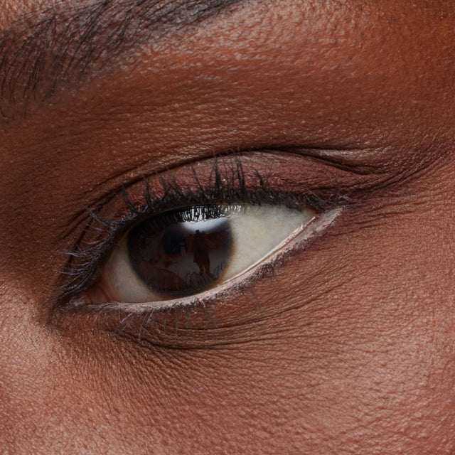 Dark brown eye model wearing Soulgazer in Gravitate