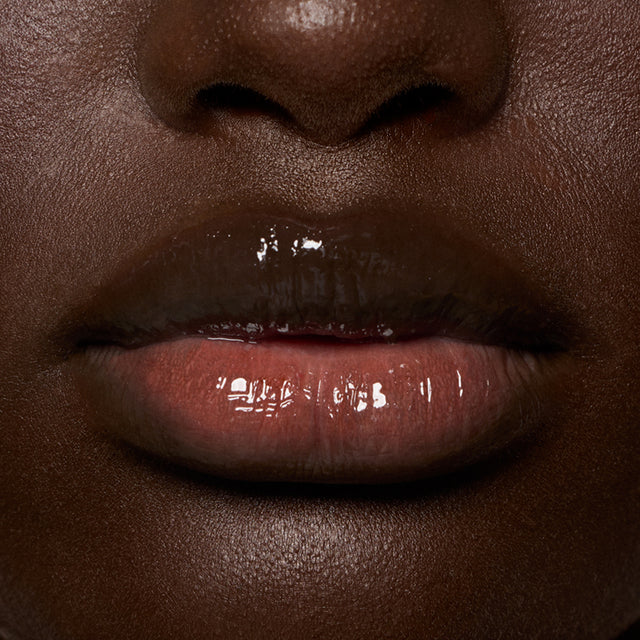 Deep skin tone model wearing Lip Pulse in Unspoken